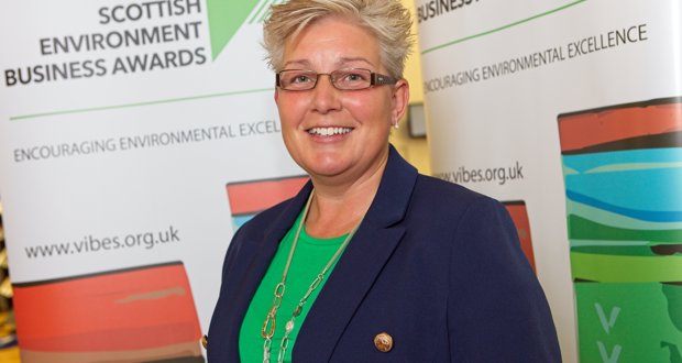 Photograph of Nicole Paterson, SEPA's CEO in front of VIBES pop up banners